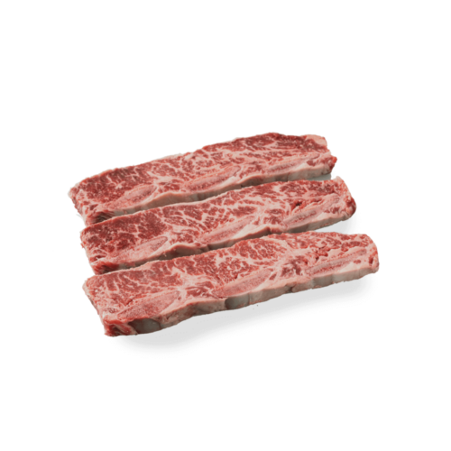 uncooked flanken style short ribs on a white background