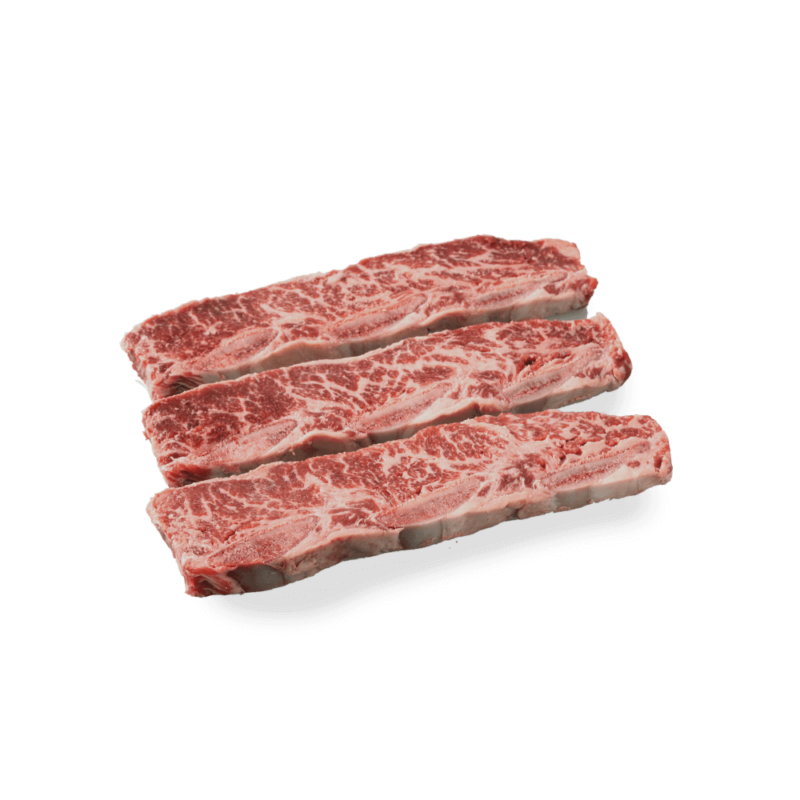 uncooked flanken style short ribs on a white background