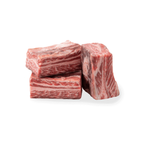 a stack of English cut short ribs against a white background