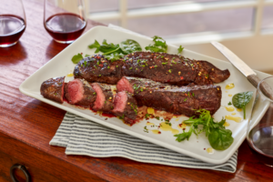 Hanger steak with chimichurri sauce on a platter