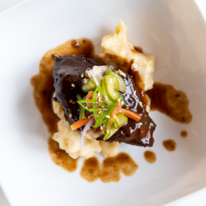 Kalbi-style short ribs (also known as Korean BBQ short ribs) served on a plate over potatoes
